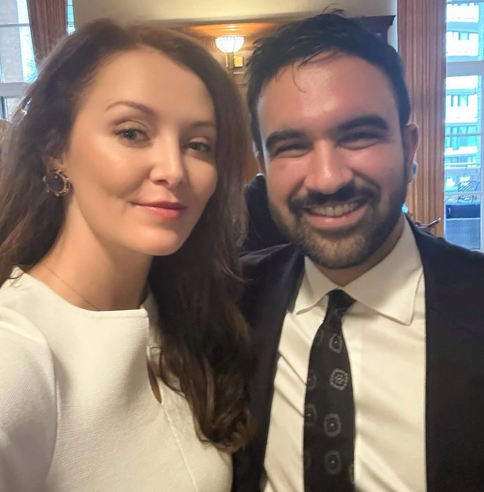 Me and Zohran Mamdani selfie. I’m in white dress he’s in suit. We are smiling. 