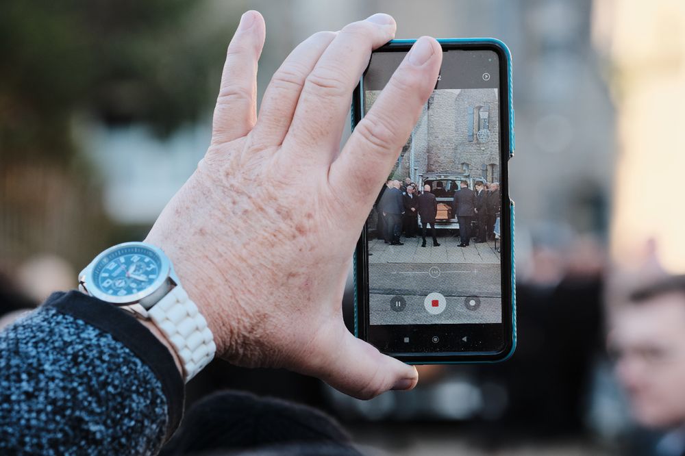 Arrival of Jean-Marie Le Pen s coffin seen through the smartphone of a spectator at Saint-Joseph church in la Trinite-sur-Mer, France on January 11, 2025.