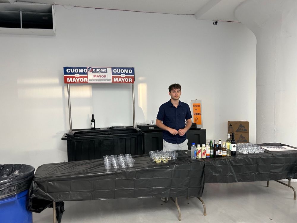 Sad cuomo volunteer tending an empty open bar 