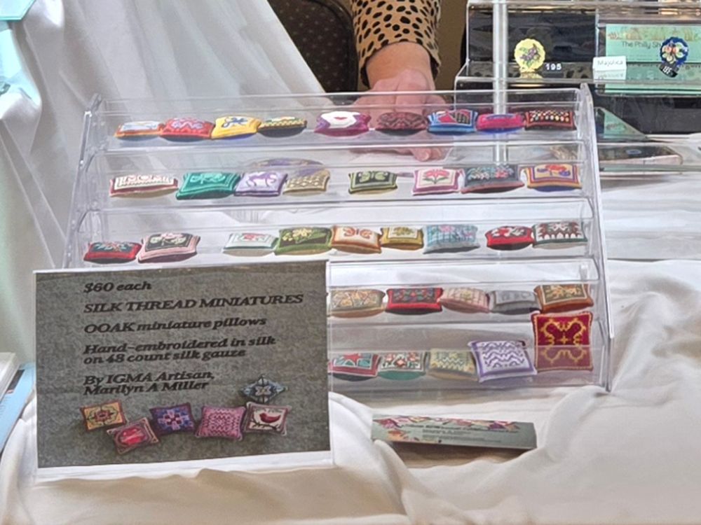 Tiny needlepoint pillows, hand made using silk thread in cross-stitch and bargello stitches.