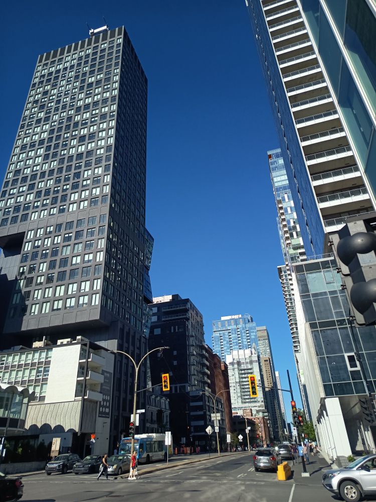 Links und rechts Hochhäuser, in der mitte eine straße