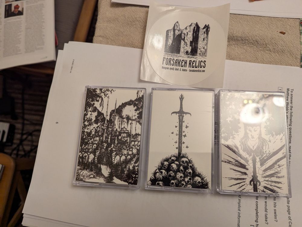 Three cassettes by Jim Kirkwood (Tales From A Melnibone Tavern, Souls That Dance On The Edge Of A Sword and Master Of Dragons, and a Forsaken Relics sticker. 
