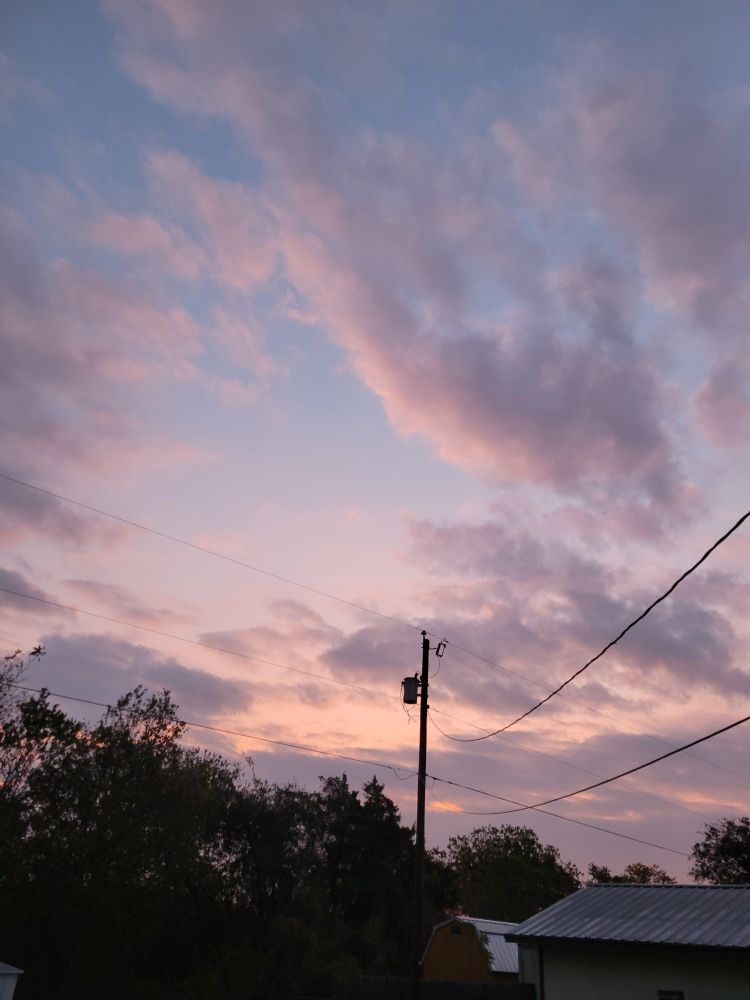 Today's sunrise is full of clouds and shades of pink, lavender, and grey