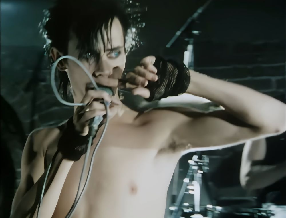 Peter Murphy of Bauhaus being awesome holding a mic 