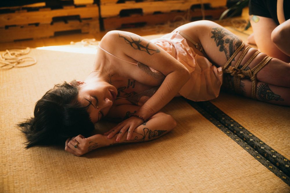 Pony collapsed on the floor legs still bound, she looks peaceful in expression 