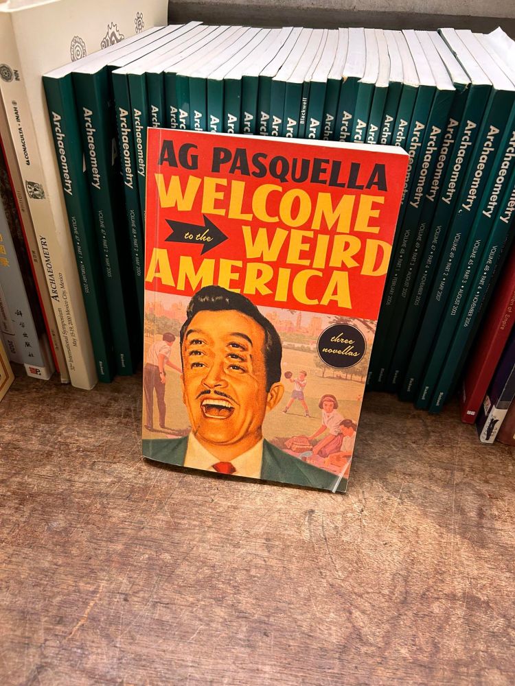A copy of my book Welcome To The Weird America propped up against some other books in the admin offices at The ROM (Royal Ontario Museum)
