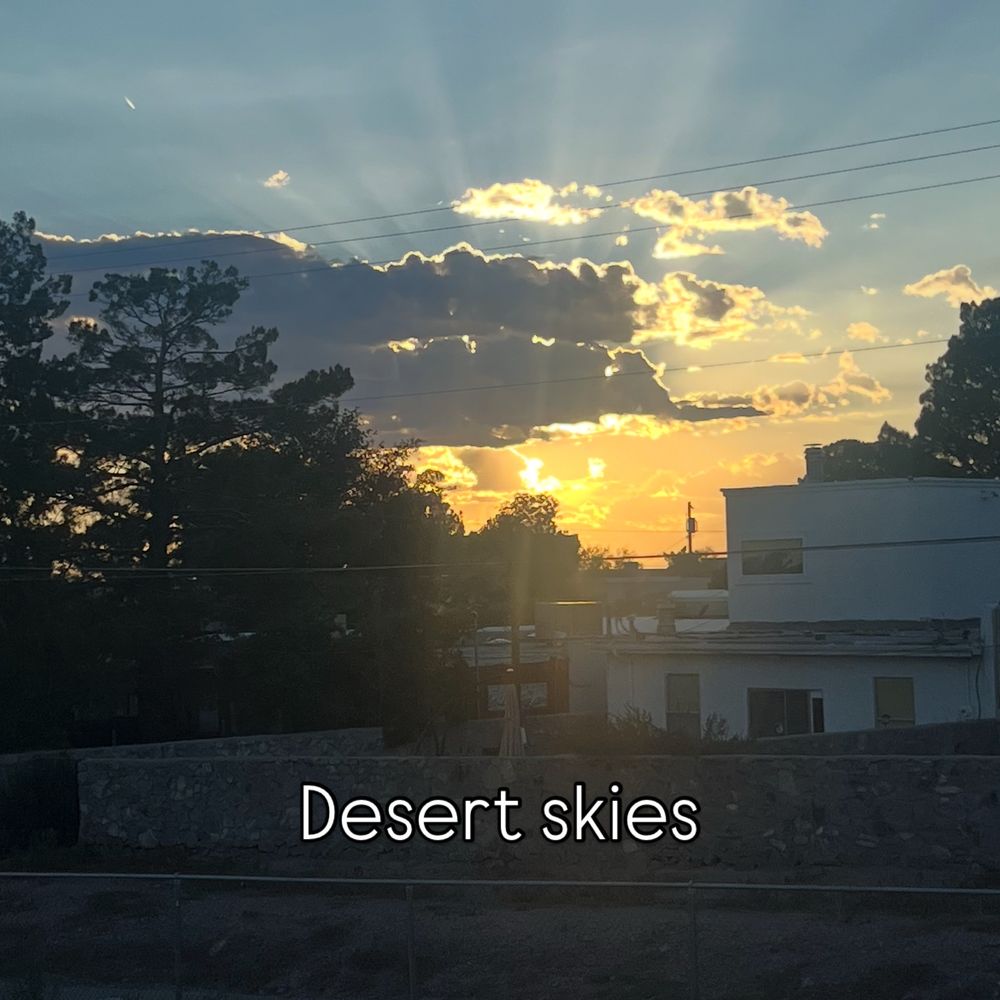 Text: desert skies 
Image sunset over trees and southwest home