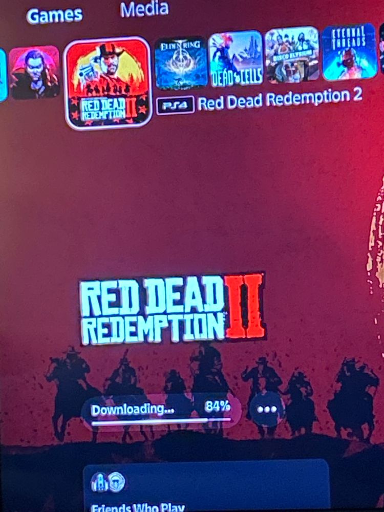 Photo of a tv displaying a download meter that reads 84% for red dead redemption 2 on playstation 