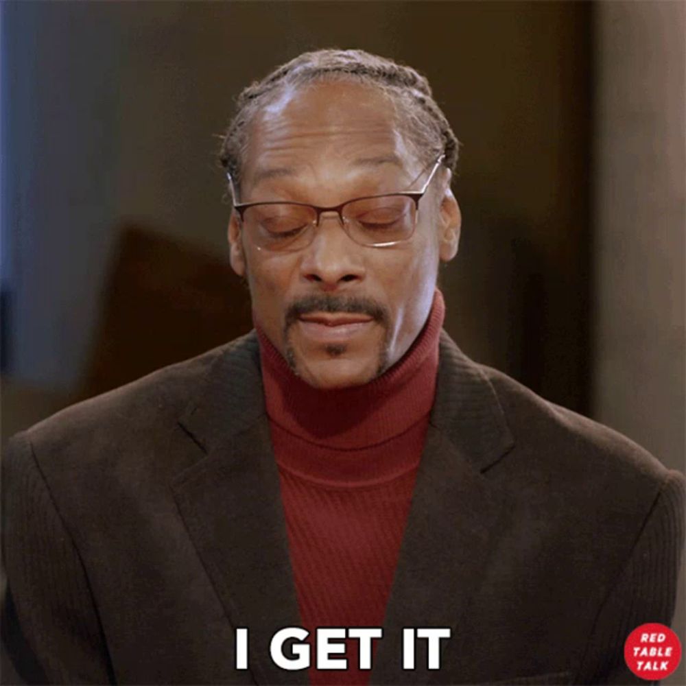 snoop dogg is wearing glasses and a red turtleneck and says i get it