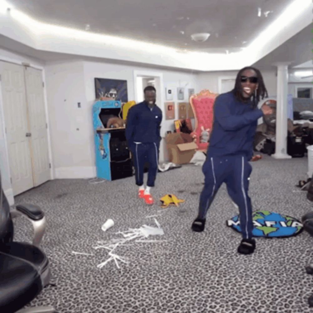 a man wearing sunglasses stands in a room with a leopard print carpet