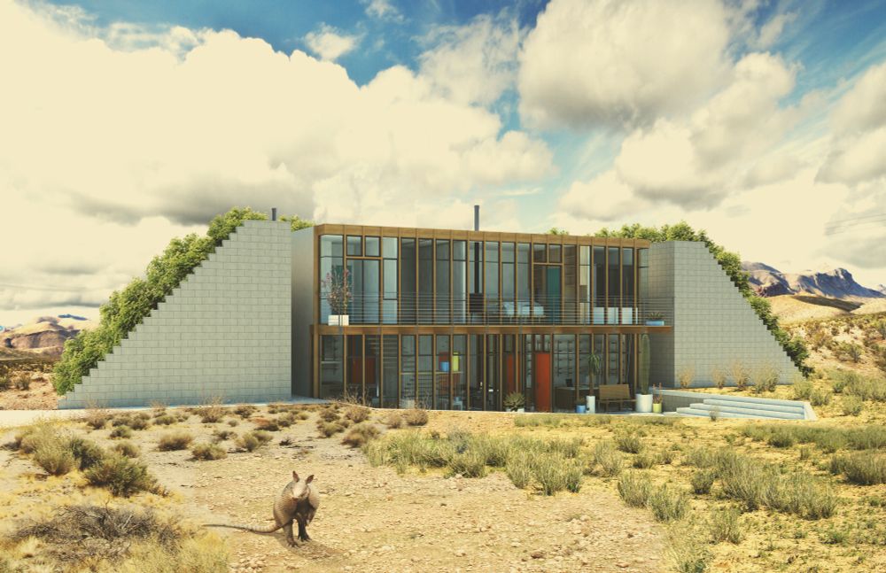 Architectural rendering of an earth-sheltered home to be located in Texas. The is surrounded by scrub, with mountains in the background, and white clouds in the sky. In the foreground an Armadillo can be seen. 