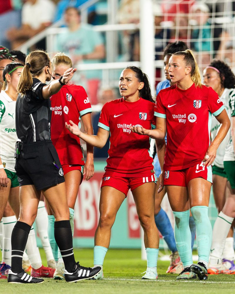 LaBonta and Hutton having the same expression and pose during the match when talking with the ref