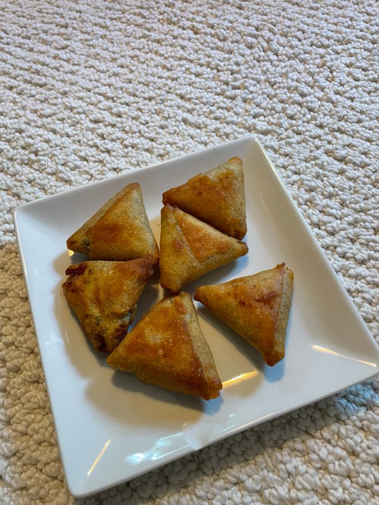 Six TJs freezer veggie samosas arranged on a lil square plate