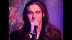 A man with long hair called Marti Pellow singing into a microphone.