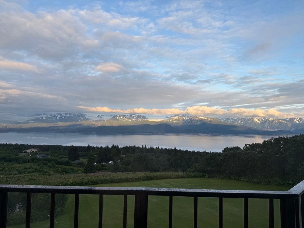 A view of Kachemak Bay with two glaciers in Kenai Fjords National Park in the background