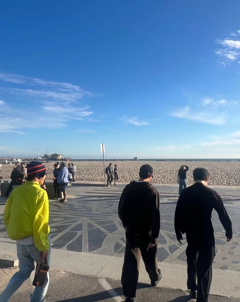 hobi joonie and jiminie walking towards the sandy beach 
