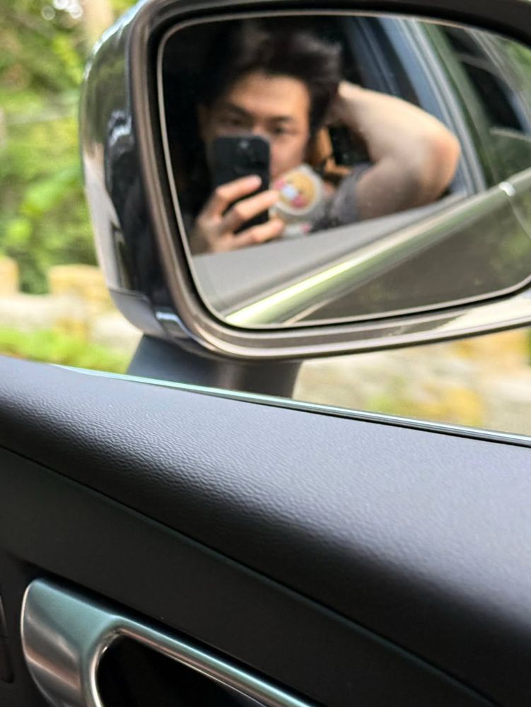 selca of namjoon through a car side mirror he’s in his military uniform 