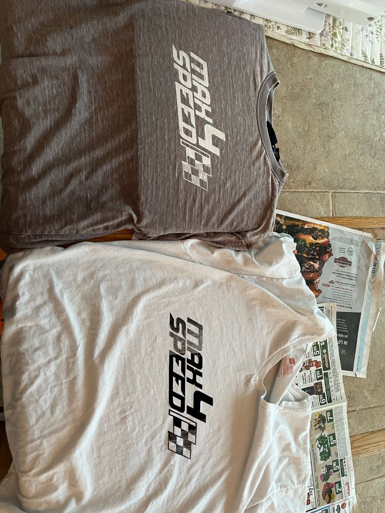 Gray shirt with white text, white shirt with black text. Shirts say “Max 4 Speed”