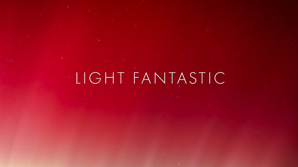 'Light Fantastic' title image is looking through a deep red aurora at a starfield.