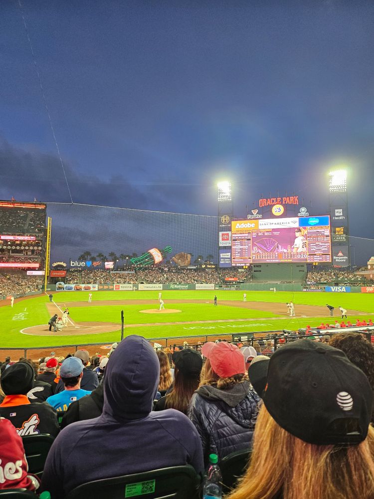 A shot of Oracle Park on a cloudy summer night.