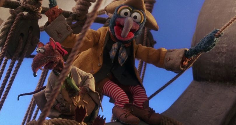 gonzo and rizzo dressed as pirates standing on the mast