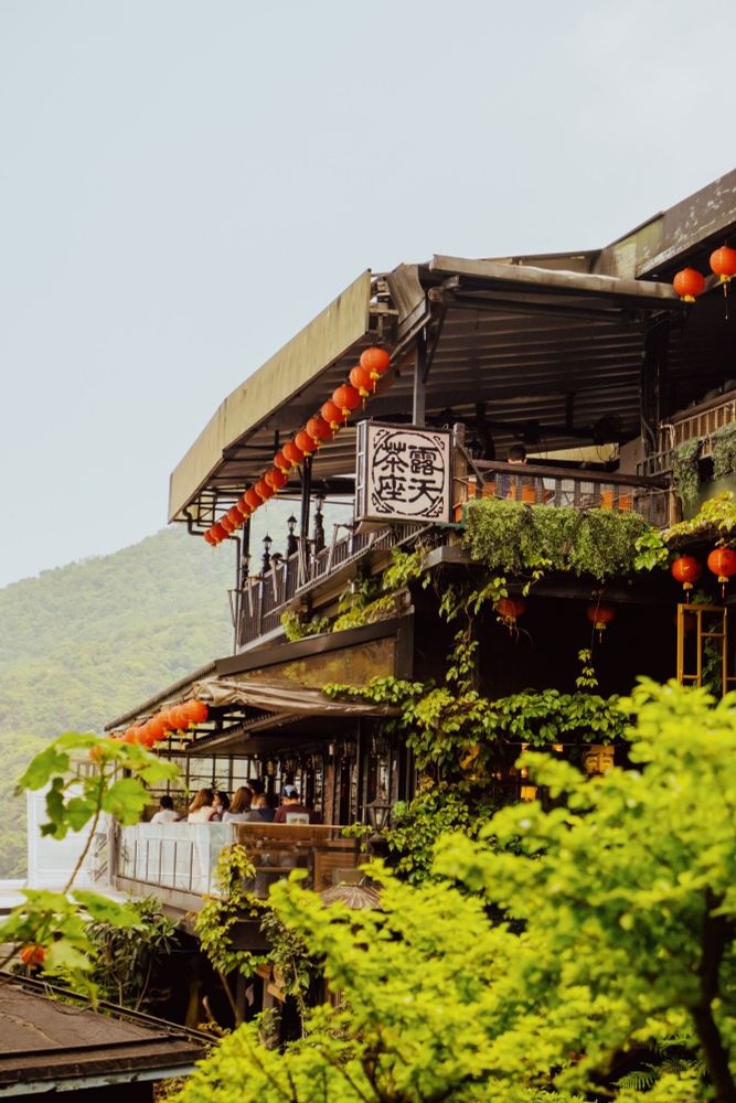 a restaurant with traditional Chinese lanterns adorning it in Jiufen Old Street