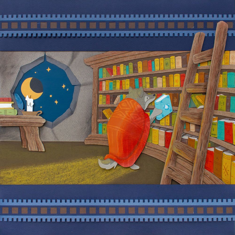 Illustration done with cut paper. This is a rather front view of the scene. We are inside the wolf's den. On the left is a desk with some books, a quill and a candle. The desk is in front of a hole in the wall, like a window, through which we see the moon and the stars. On the right, about 50 percents of the picture is occupied by a big book shelf, with books of all colours. On the far right there is a wooden ladder. At the center of the picture, the wolf just picked up a blue book with the drawing of the necklace on it.
There is a blue frame with repetitive patterns above and below the picture.