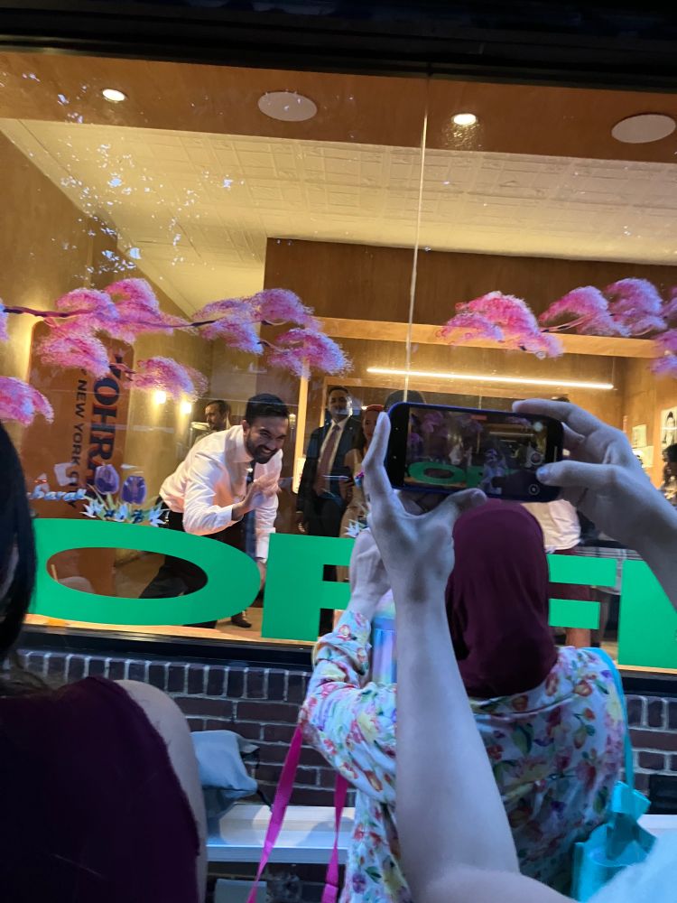 Zohran saying hi to a child through a window 