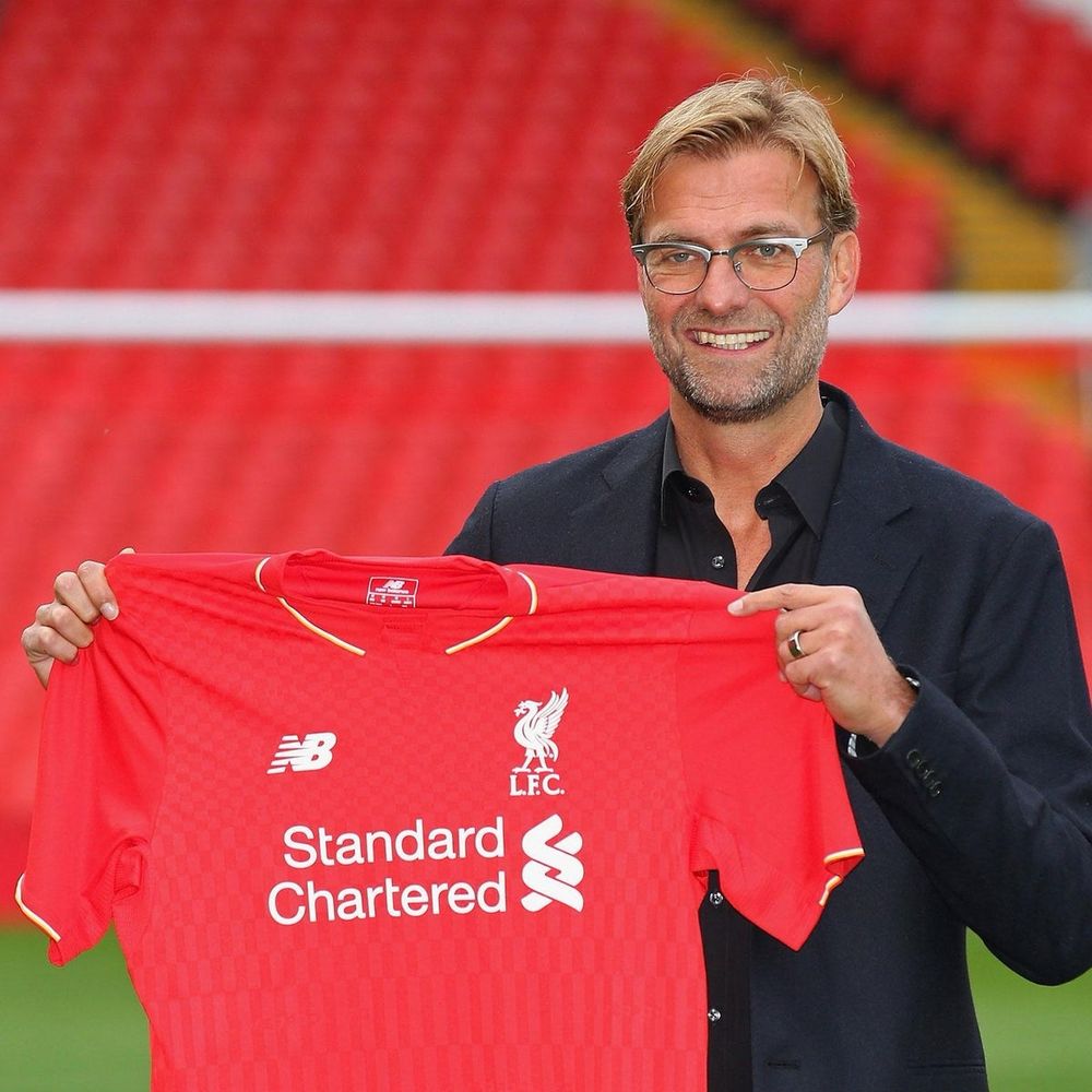 Jurgen Klopp holds Liverpool shirt at Anfield, 8 October 2015. 