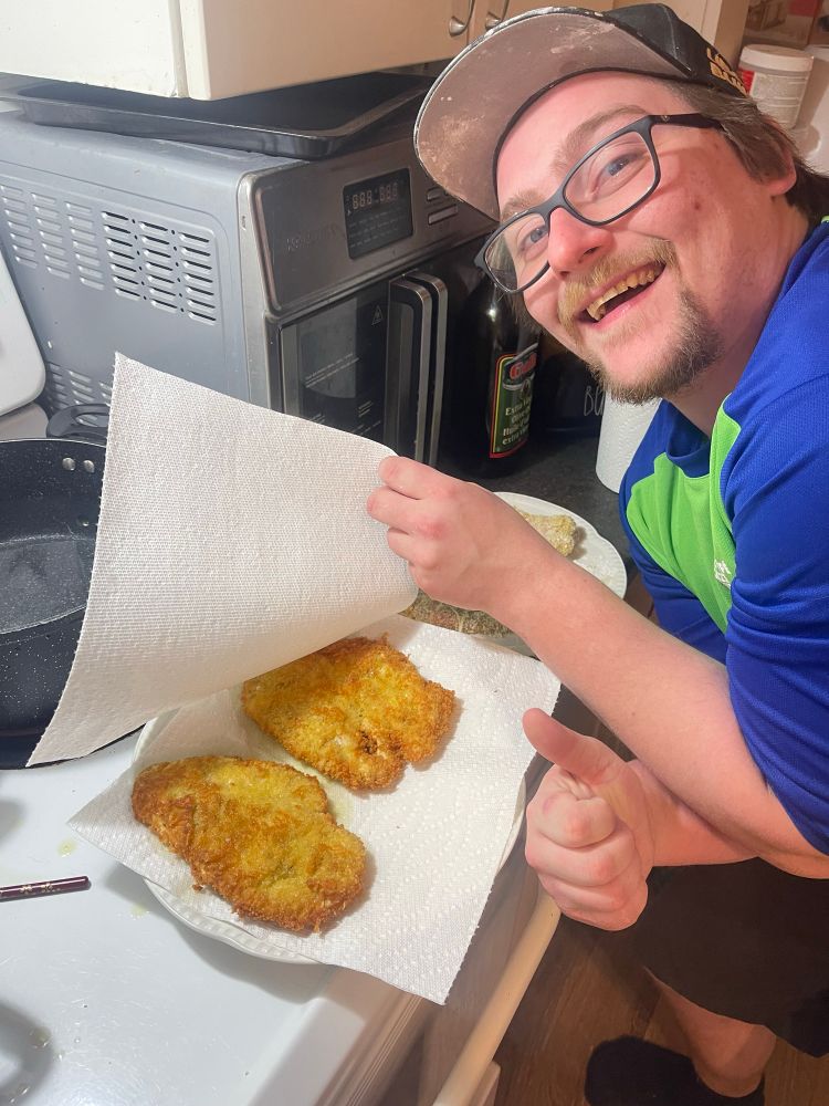 Daniel with a thumbs up with the chicken 