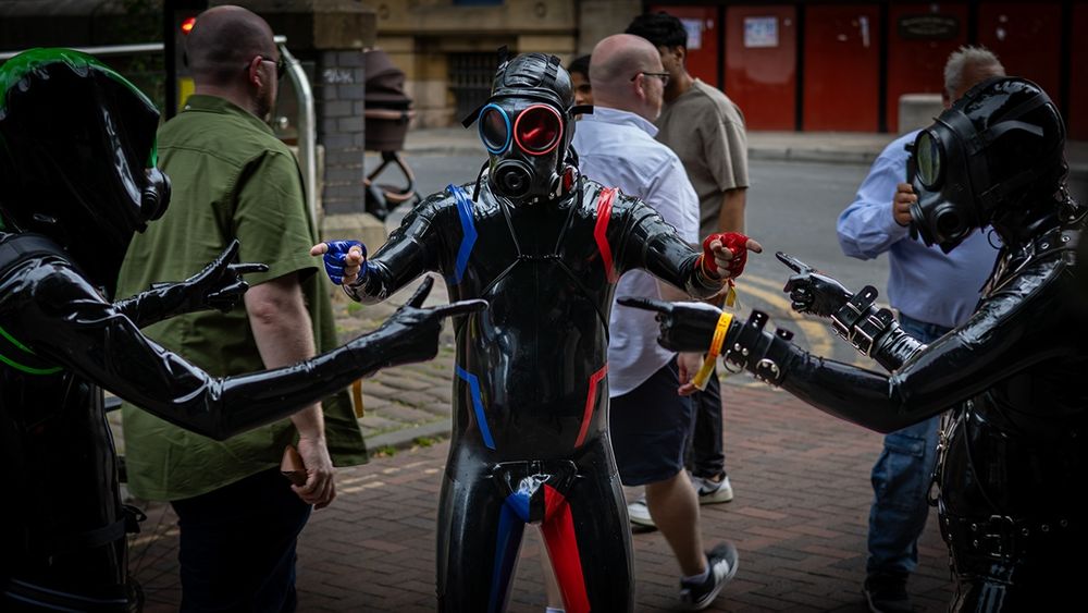 Three latex drones pointing at each other in a Spiderman meme style 