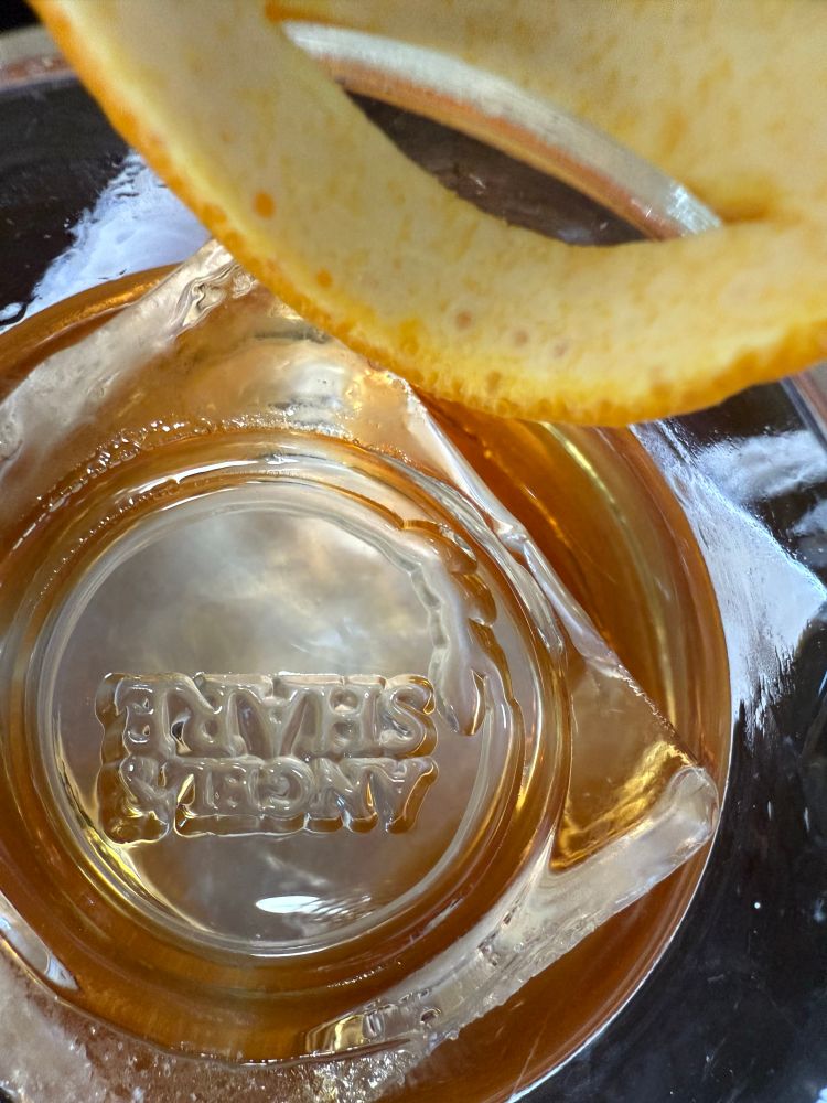 Stamped artisanal ice, it reads: Angel’s Share, the name of the joint. 