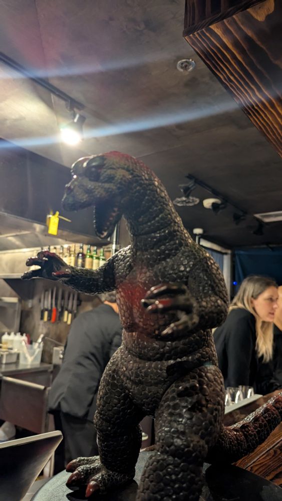 A Godzilla doll on the shelf in a Japanese restaurant in Seattle.