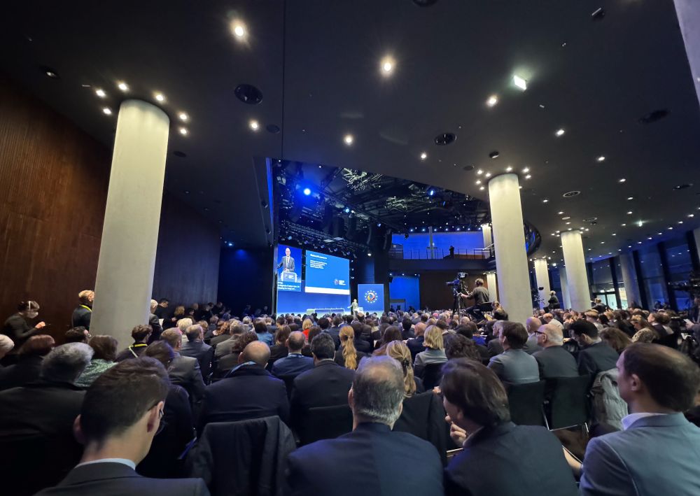 A room filled with people and a stage 