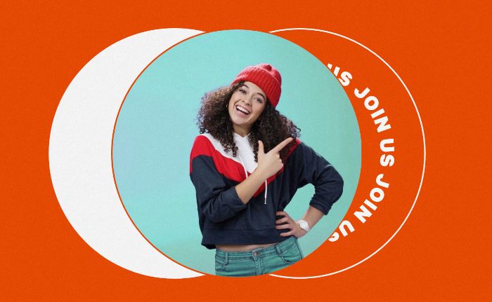 woman with dark curly hair wearing a red toque and a red, white and navy blue jacket pointing to the words Join Us.