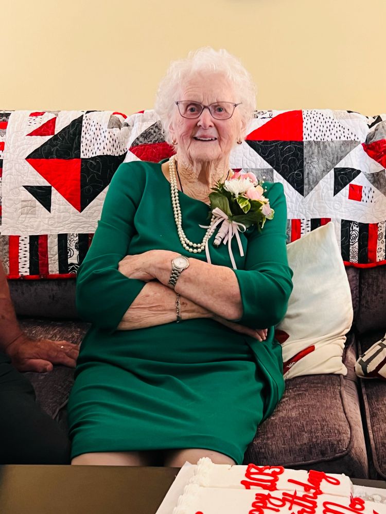A beacon of a woman is wearing a lovely green dress and a warm smile as she celebrates her 103rd birthday surrounded by her family in a fishing village on the coast of Newfoundland. Her name is Marie Fred Sullivan and you’d be lucky to meet her.