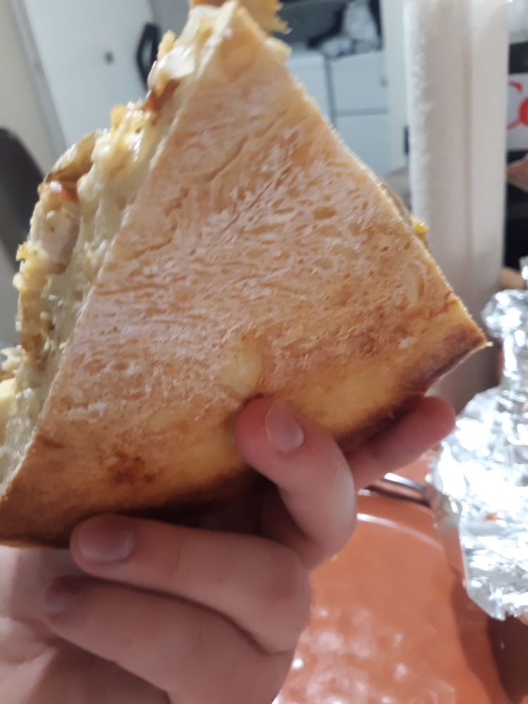 the bottom of a slice of pizza, showing the quality of the crust