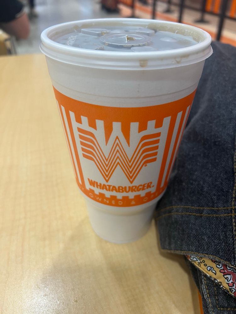 A styrofoam cup with the Whataburger logo