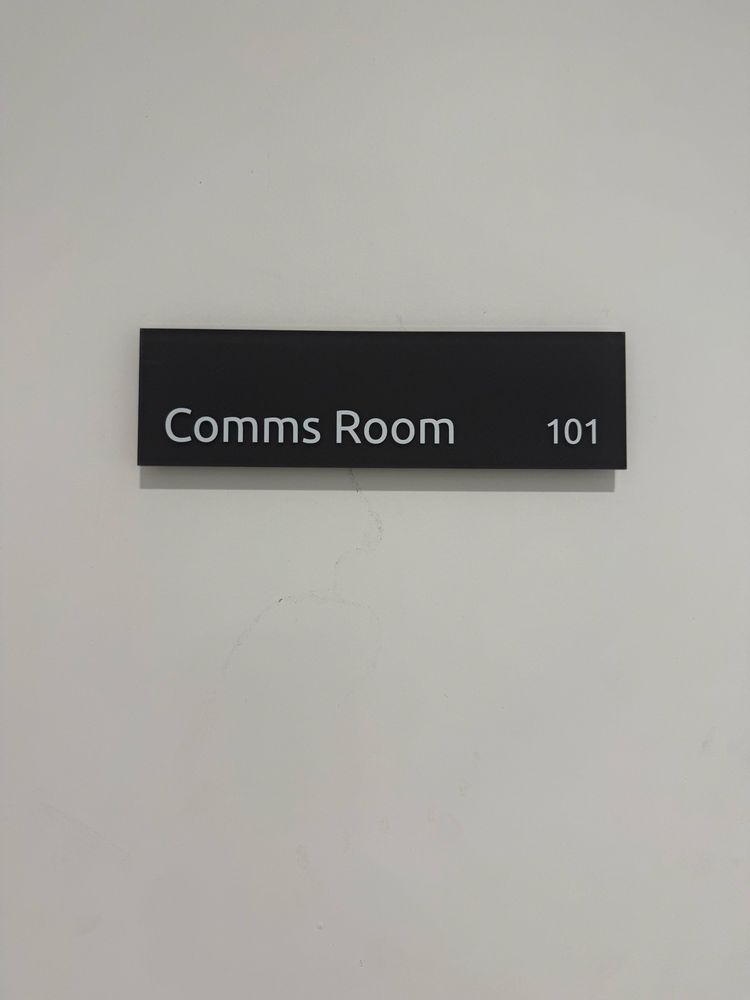 A sign reading Comms Room 101

