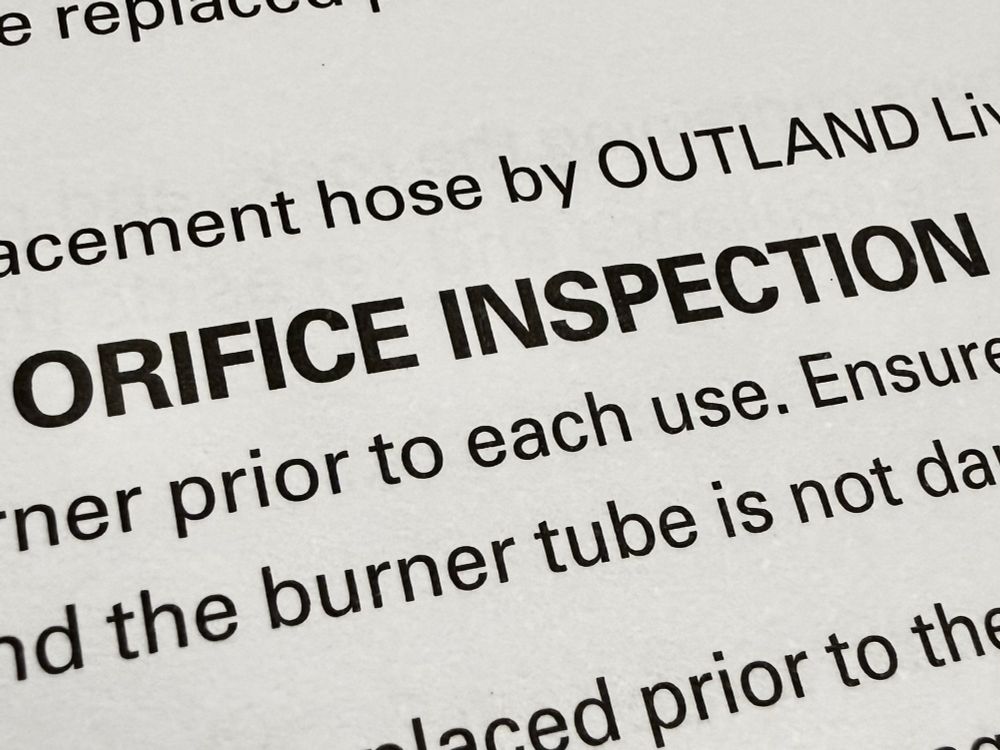 Photograph of a closeup of a printed page. Prominently featured in bold text are the words “ORIFICE INSPECTION”. 