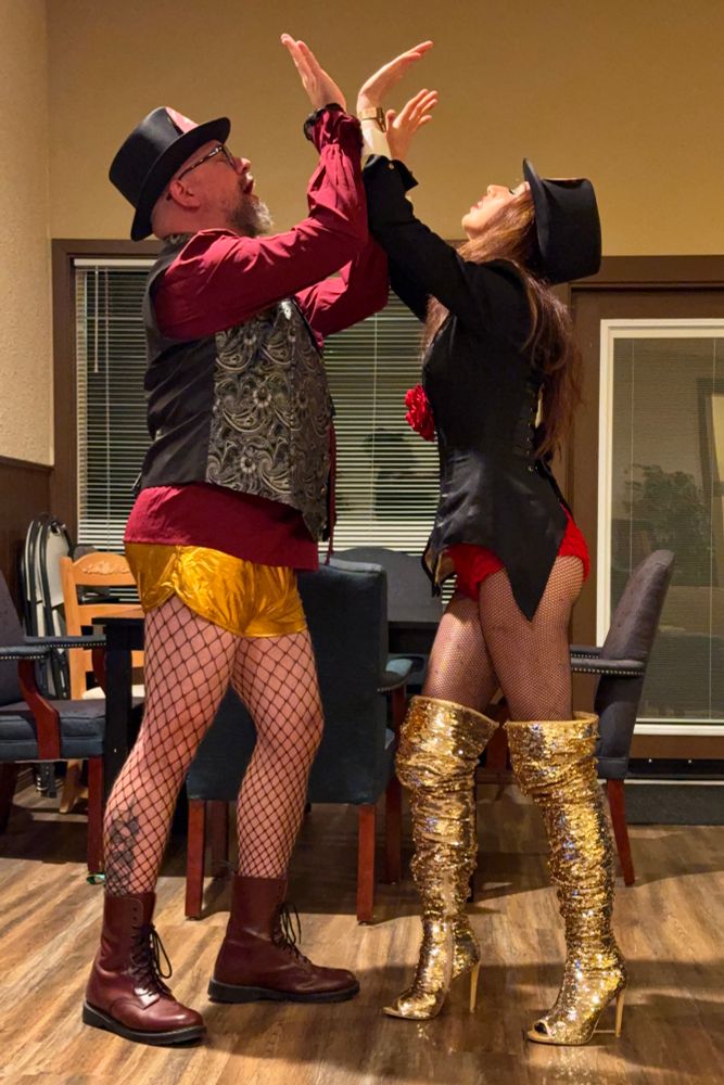 Photograph of the two people from the previous photo, in the passionate throes of “elbow sex”. 