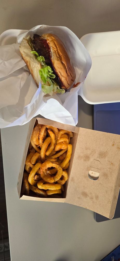 Cheeseburger and box of curly fries