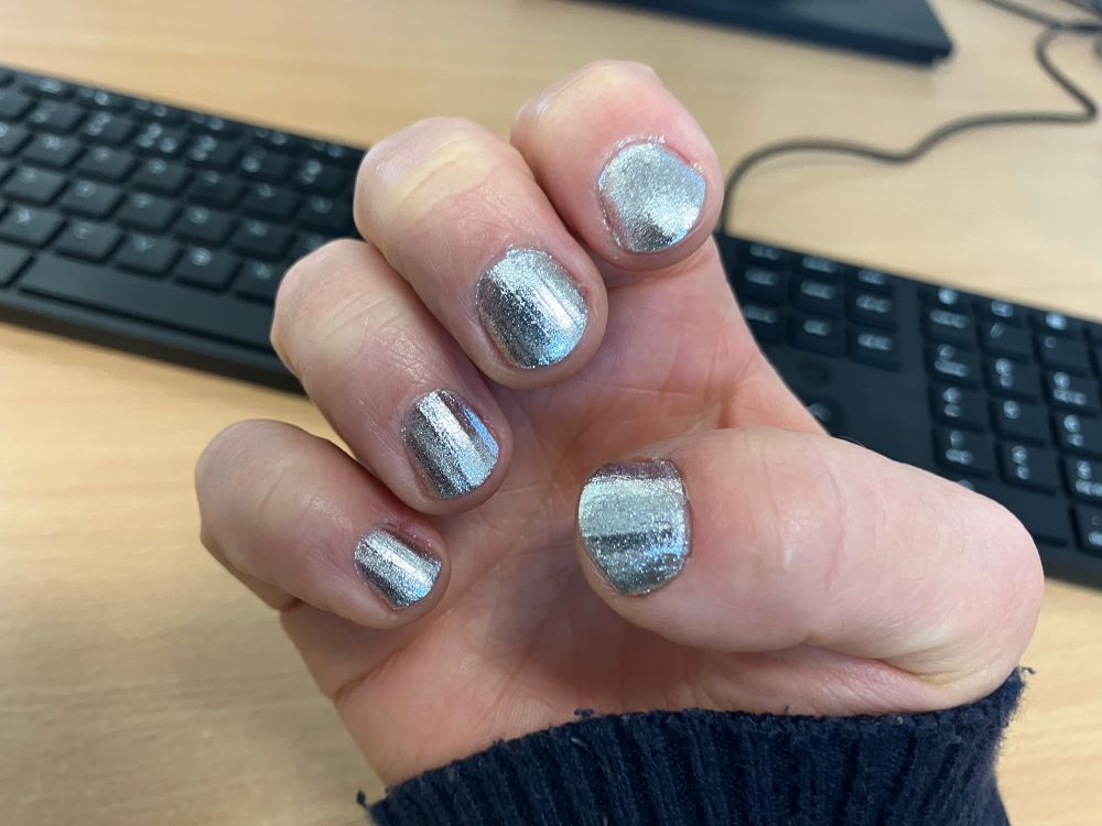 My right hand showing highly silver nails (micro flakie silver polish). Looks like liquid silver but sparkly. 