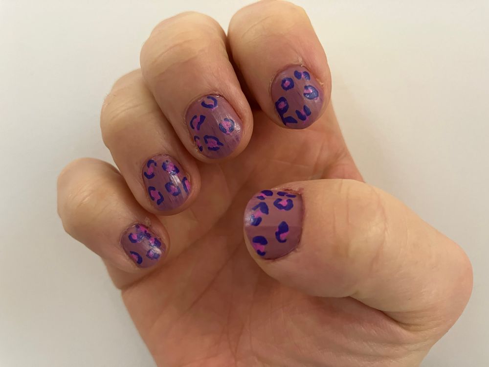 My right hand showing purple and pink leopard print effect on a dusky pink base 