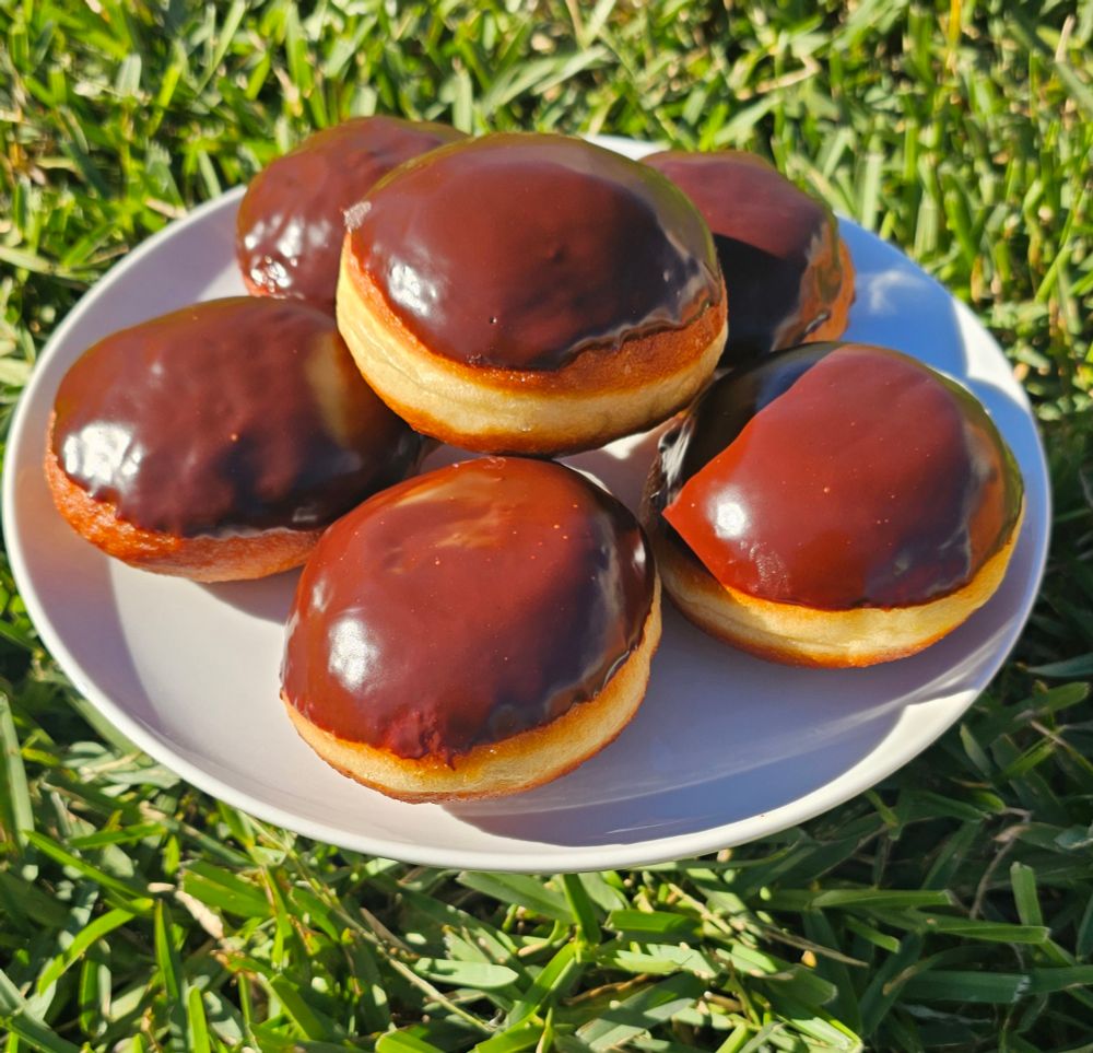 A plate of Boston cream pie donuts filled with brown sugar creme patisserie. 
