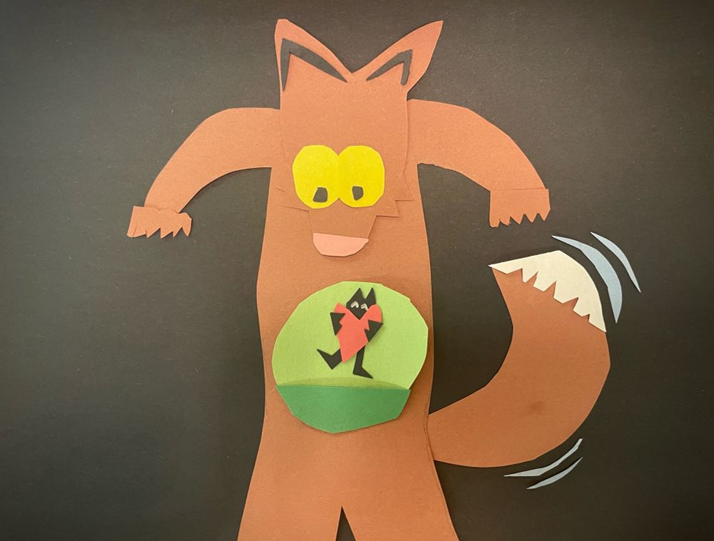Construction paper artwork of a fox getting his heart hugged by someone cute