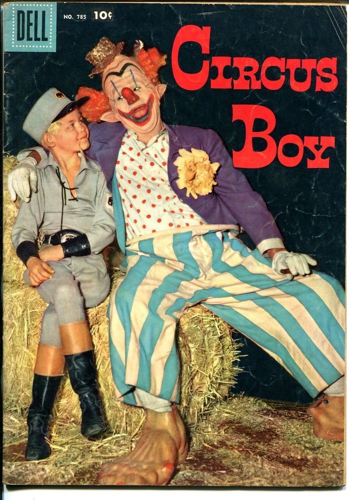 A cherubic child sits atop a hay bale and looks adoringly at a grotesque clown. The cover of Circus Boy #785 from Dell Comics. 1957. The boy is a young Micky Dolenz. 