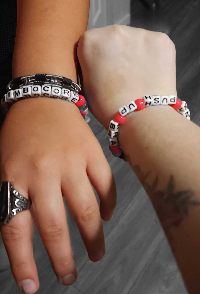 Kandi bracelets we received. Mine had blue and pink beads and said "bimbocore," star's said "pink push up bra" with pink beads