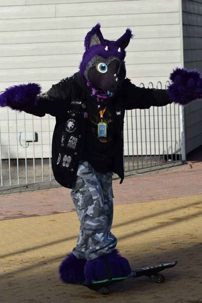 Purple dergon mounting a skateboard