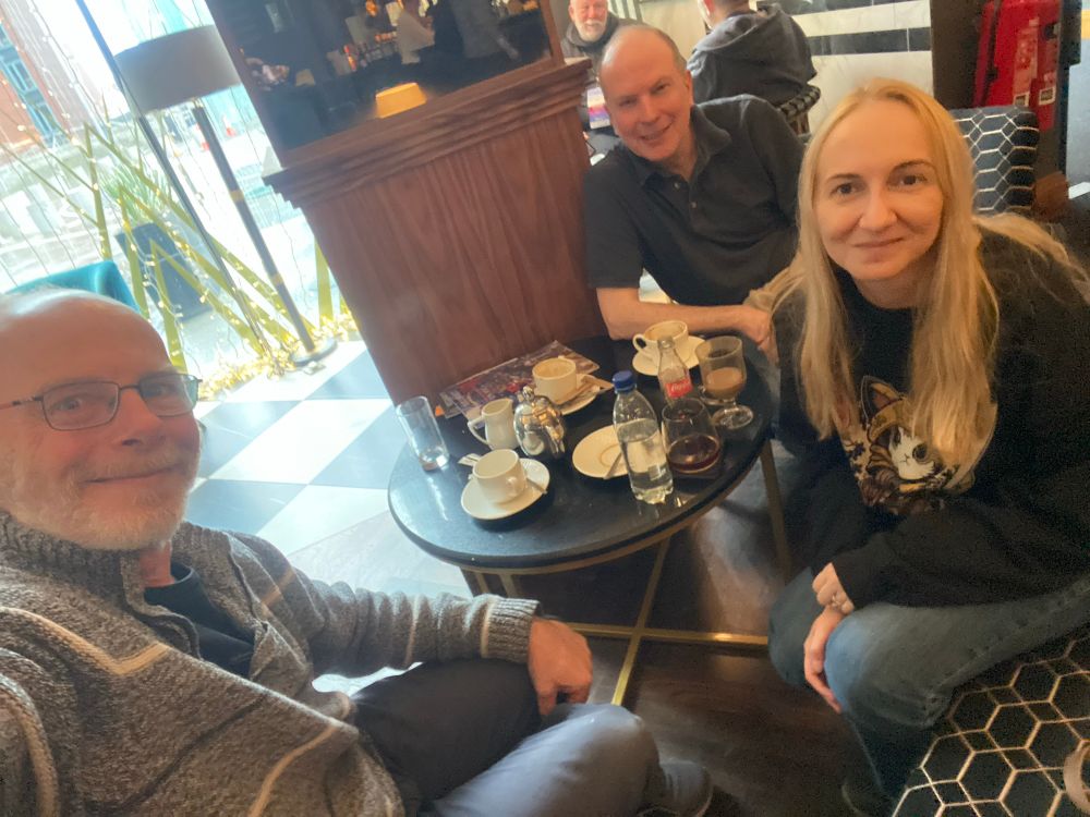 Authors TOMunro, Mark Lawrence and Mitriel Faywood sitting around a low table in a bar